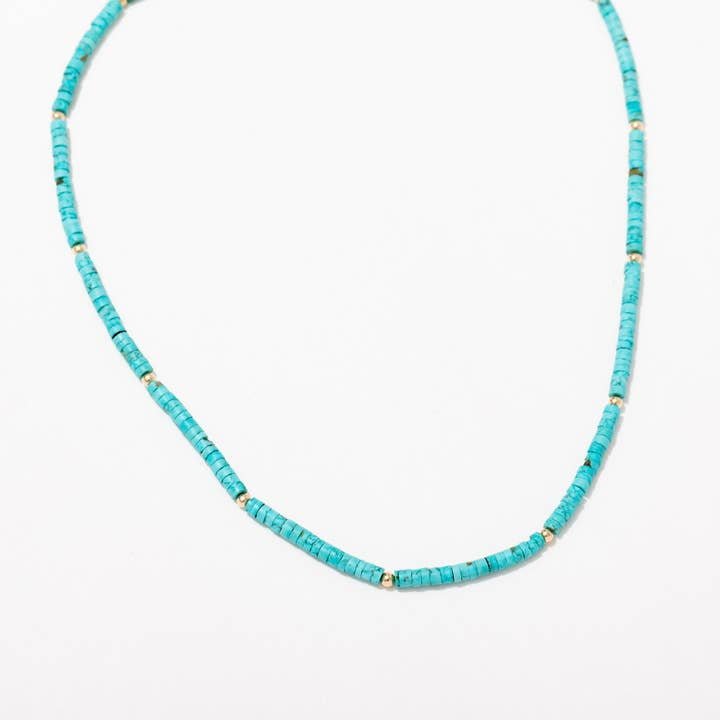 The Larissa Loden Turquoise Beaded Layering Necklace features turquoise beads with small gold spacers, an adjustable length for a perfect fit, and is displayed against a white background.