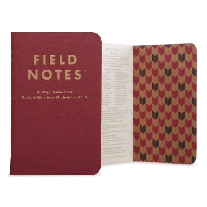 A closed and open Vintage | Field Notes memo book by Field Notes is shown, displaying its linen textured cover, 48 pages, patterned inside covers, and printed information page.