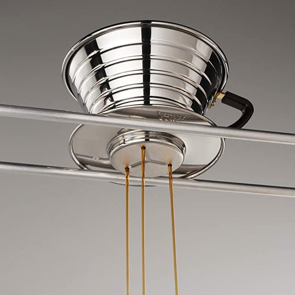 A stainless steel Wave 155 Coffee Dripper by Kalita, pouring three narrow streams onto two parallel metal rodsāevoking a pour-over setup like the Kalita Wave Dripper.