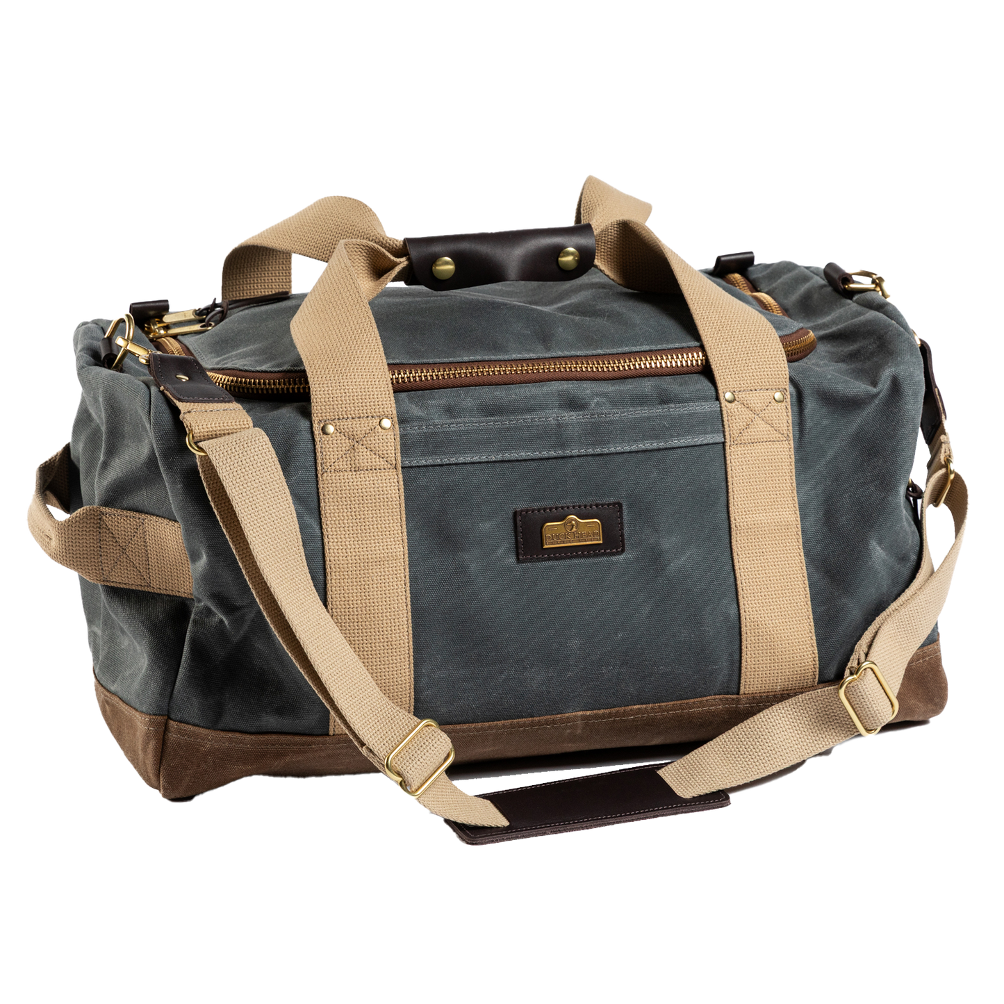 The Duck Head Waxed Canvas Overnighter Bag in charcoal features tan straps, gold-tone hardware, a front pocket, and a detachable shoulder strap. Made in the USA, it's your durable travel companion.