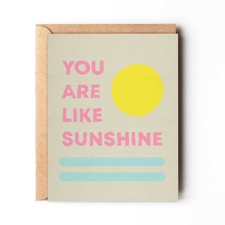 The "You Are My Sunshine" card by Daydream Prints features a yellow circle, blue lines, and pink "YOU ARE LIKE SUNSHINE" text on beige. Includes recycled envelope—ideal blank card for any occasion.