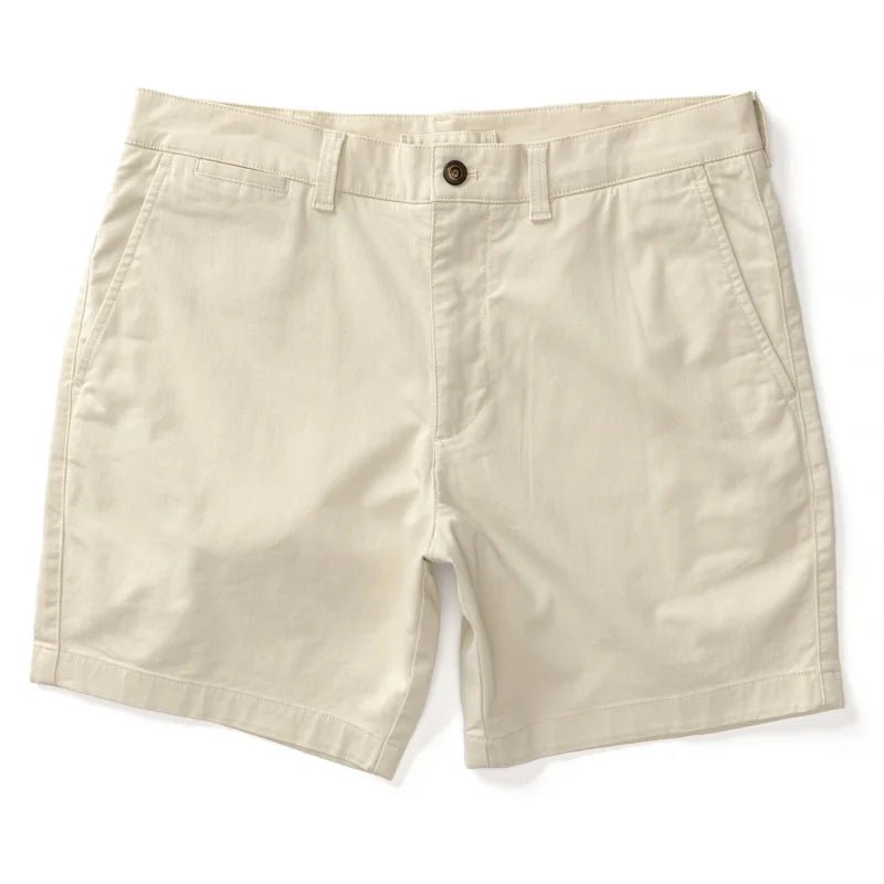 The 7 in Gold School men's chino shorts by Duck Head in beige feature belt loops, a front button closure, and side pockets, shown on a white background.