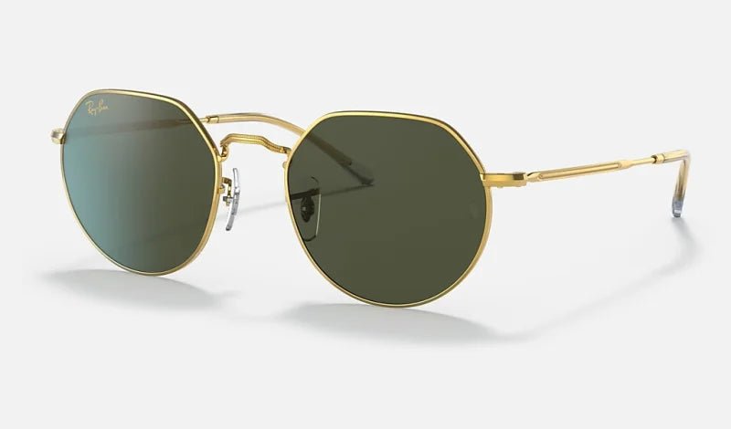 A pair of Ray-Ban Arista sunglasses with gold metal frames and blue gradient grey lenses on a white background.