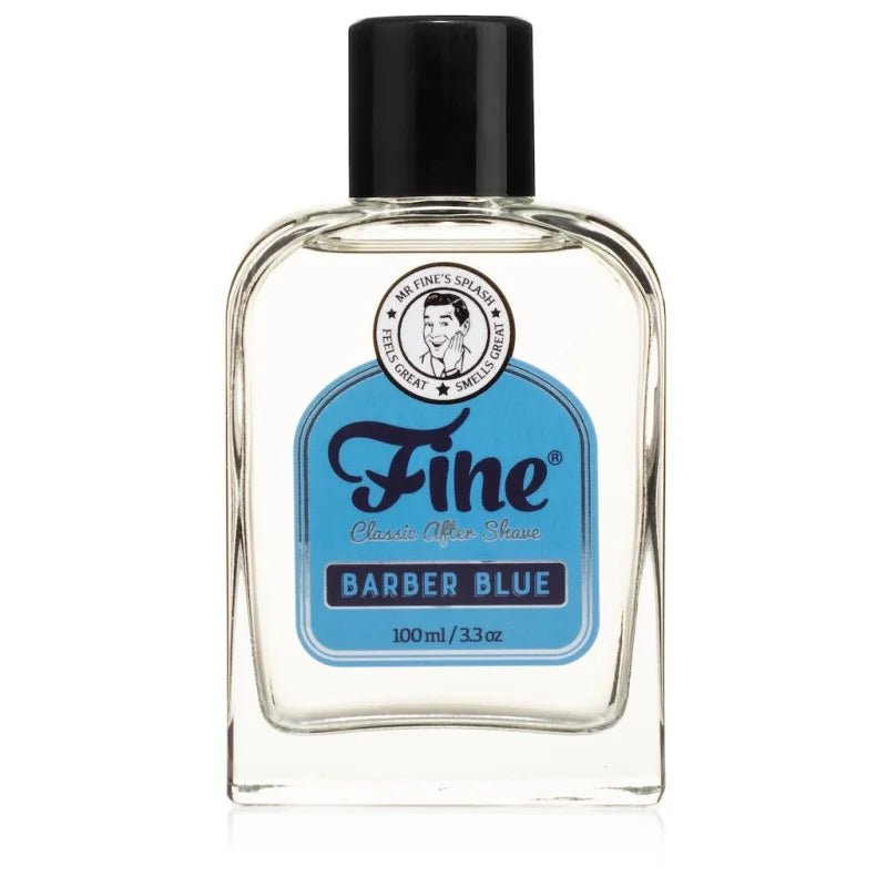 A clear glass bottle of Fine Accoutrements Barber Blue Classic Aftershave, featuring a black cap and blue label, contains 100ml (3.3oz) of refreshing aftershave in the signature Barber Blue scent.