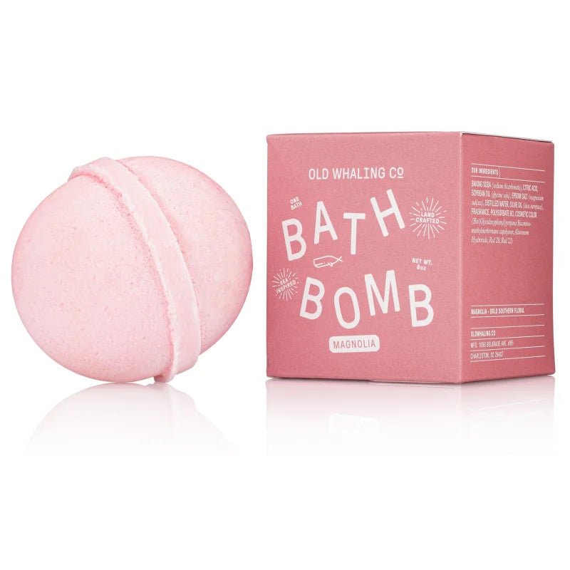 A pink bath bomb rests beside its matching box labeled "Bath Bomb | Magnolia | Old Whaling Co."—an ideal pick from Old Whaling Co. for a relaxing soak with epsom salts.