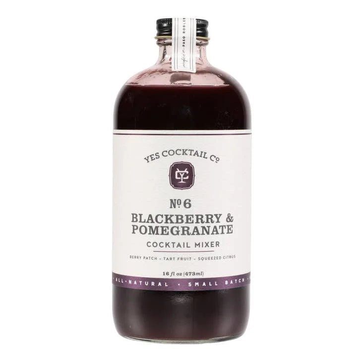 A 16 fl oz (473 mL) glass bottle of Yes Cocktail Co. Blackberry + Pomegranate Cocktail Mixer, filled with dark purple berry syrup.