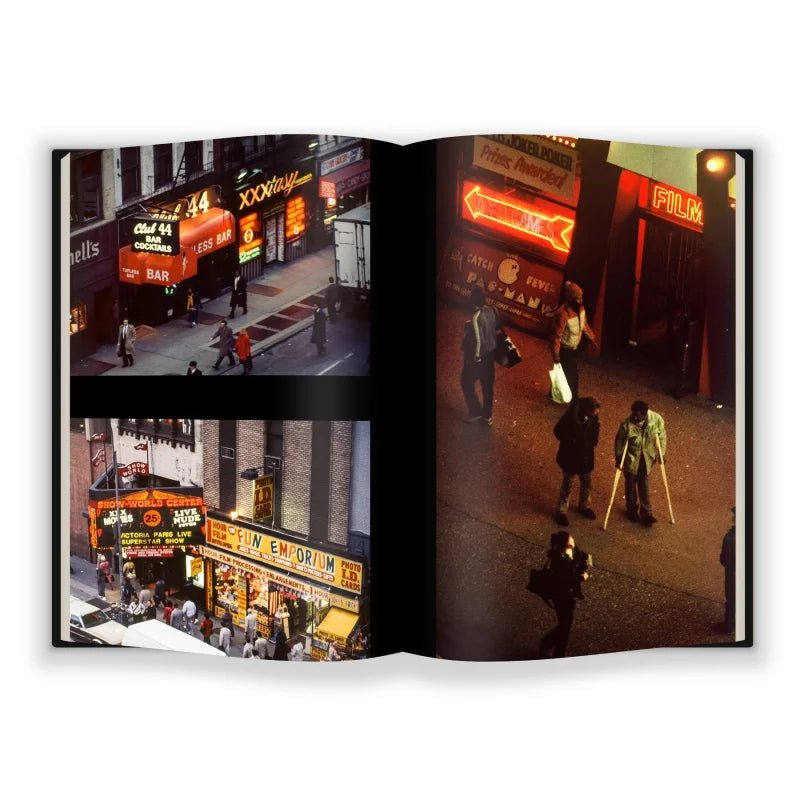 An open book, "Jane Dickson in Times Square" by Anthology Editions, reveals vivid photos of neon-lit city nights and bustling streets—a striking tribute to Jane Dickson and the New York City art scene.