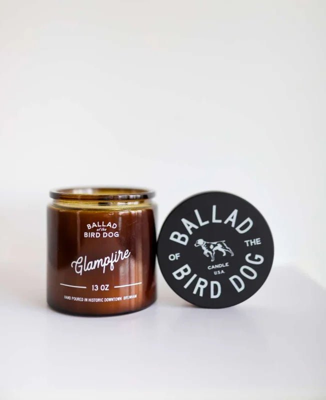 The Ballad of the Bird Dog Candle | Glampfire features a cozy Texas campfire scent with Arabian wood notes, all in a lidded jar—perfect for starry nights.