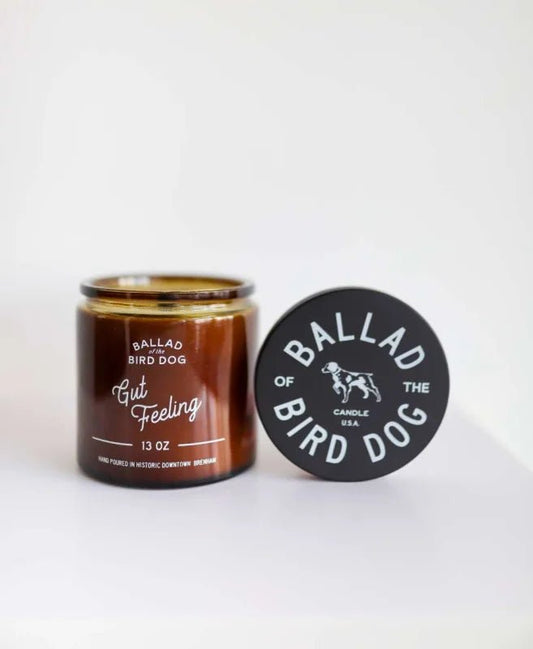 The Candle | Gut Feeling by Ballad of the Bird Dog comes in a brown glass jar with a black lid and features subtle Hinoki and Yuzu Blossoms notes in its scent and design.