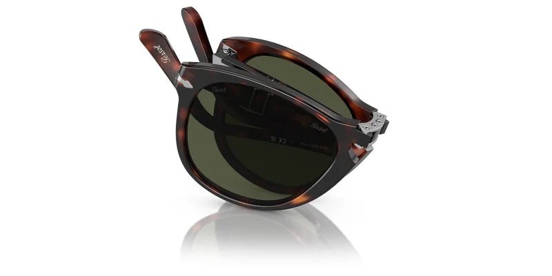 Persol Folding Havana w/ Green (0PO0714) glasses, partially folded, shown against a white background with faint reflection.