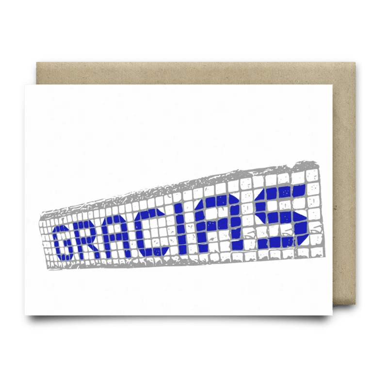 Gracias Blue Tiles Card by Anvil Cards: A2 greeting card with "GRACIAS" in blue on a mosaic tile pattern, printed on linen paper, blank inside, shown with a brown envelope.