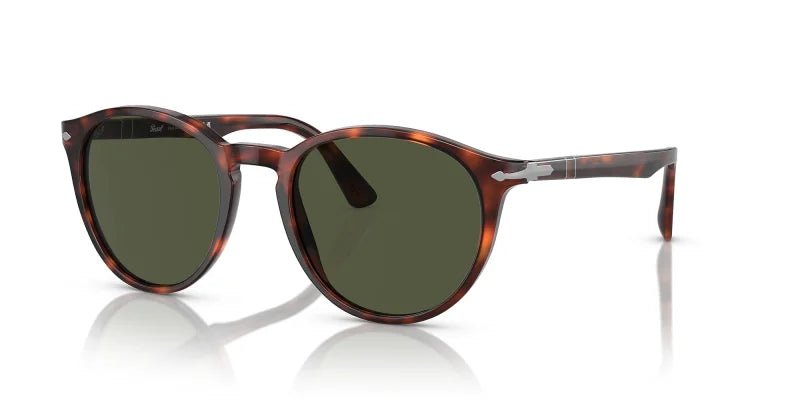 The Persol 0PO3152S sunglasses in Havana with green lenses feature a round phantos frame and silver accents, showcasing Italian craftsmanship.