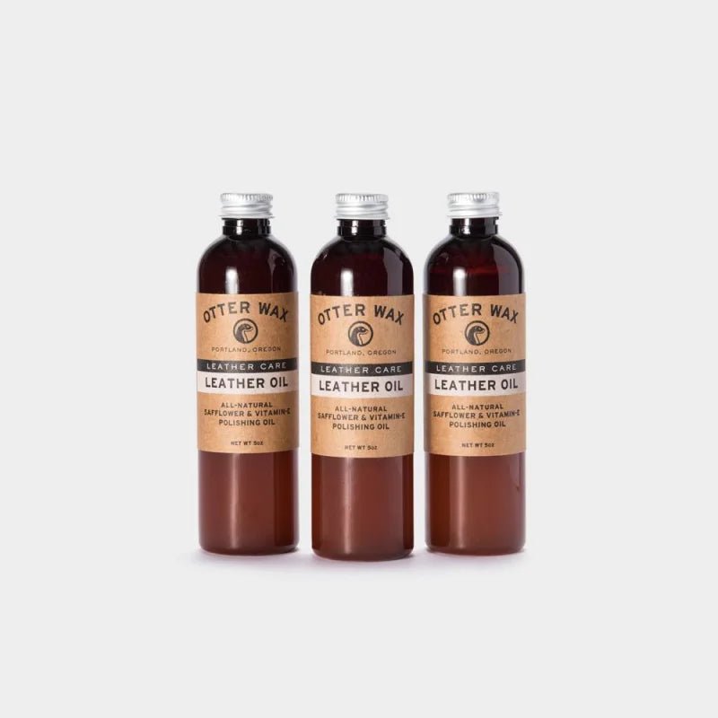 Three bottles of Otter Wax Leather Polishing Oil, featuring beige labels and metal caps, are arranged upright against a plain white background.
