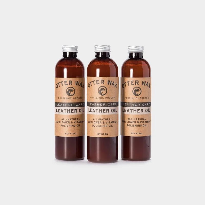 Three bottles of Otter Wax Leather Polishing Oil stand side by side on a light background—ideal for conditioning and protecting your favorite leather goods with this all-natural care solution from Otter Wax.