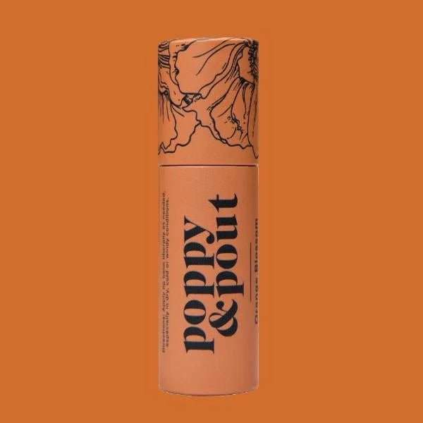 An orange cylindrical tube labeled "Poppy & Pout" with floral line art on the cap sits on an orange background, highlighting the cruelty-free, natural Lip Balm | Poppy & Pout by Poppy & Pout.