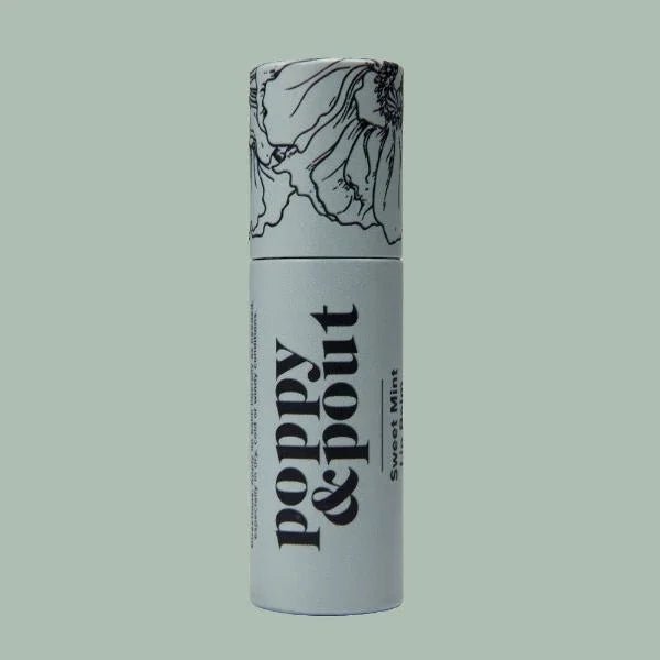 A cylindrical tube of Poppy & Pout Lip Balm in Sweet Mint, decorated with floral line art and bold black text on a pale green background.