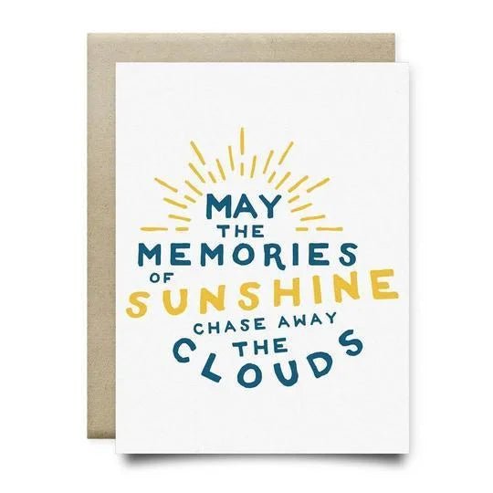 The "Memories of Sunshine Sympathy Card" by Anvil Cards is an A2 linen card with "May the memories of sunshine chase away the clouds" in blue and yellow and a sunburst design. Blank inside for your message.