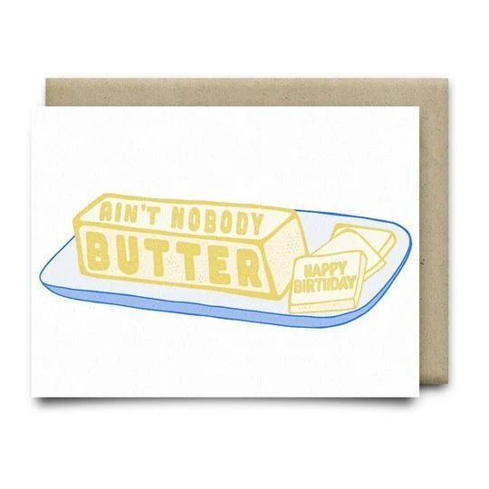 Anvil Cards’ Nobody Butter Birthday Card features butter sticks—one labeled "Ain't Nobody Butter," the other "Happy Birthday"—on an A2 linen paper greeting card, blank inside, with envelope included.