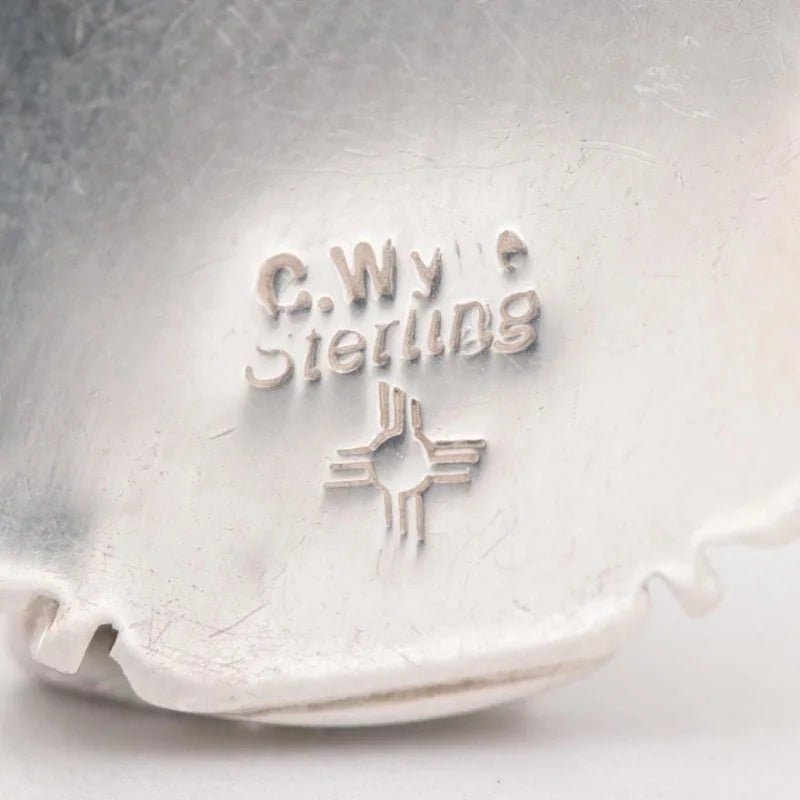 Close-up of a vintage sterling silver opal pendant, branded "Vintage," stamped with "C. Wyte Sterling" above a Zia sun symbol.