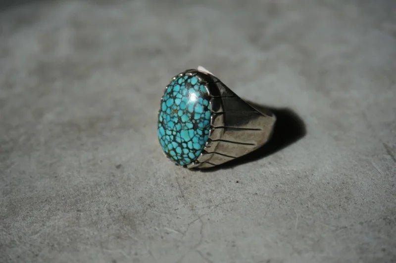 Silver spiderweb turquoise ring featuring a vibrant turquoise stone for vintage style