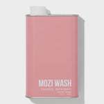 A rectangular pink metal container labeled “Desert Poppy Laundry Detergent | Mozi” with a white screw cap, featuring a delightful floral fragrance reminiscent of fresh laundry and blooming Desert Poppy.