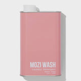 A rectangular pink metal container labeled “Desert Poppy Laundry Detergent | Mozi” with a white screw cap, featuring a delightful floral fragrance reminiscent of fresh laundry and blooming Desert Poppy.