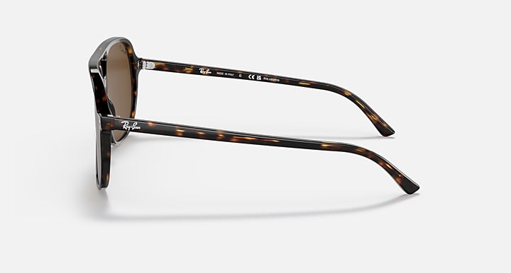 A pair of Ray-Ban Bill RB2198 sunglasses in Havana, featuring tortoiseshell frames viewed from the side, with a focus on the temples, polarized lenses, and the signature Ray-Ban logo.