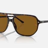 Ray-Ban 2205 Bill One sunglasses in tortoiseshell with brown lenses and subtle Ray-Ban logos on the corners, shown on a white background. These vintage-inspired shades offer classic, timeless style.