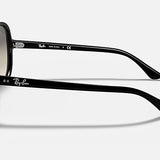 The Ray-Ban RB4125 sunglasses are featured from a side angle, highlighting the iconic brand logo on both the temple and inside arm. These sunglasses showcase a polished black frame with light grey gradient lenses, set against a plain white background for a modern look.