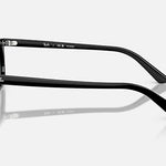Zaya RB4456F sunglasses by Ray-Ban shown in a side profile on a white background, highlighting the Ray-Ban logo on both the temple and temple tip. These sunglasses feature a sleek black injected frame paired with polarized dark grey lenses, offering a modern and sophisticated aesthetic.