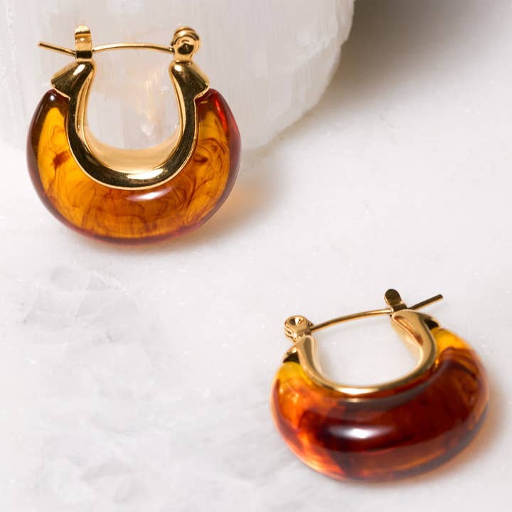 Selma Hoops featuring translucent amber-colored resin loops with 18k gold-plated posts.