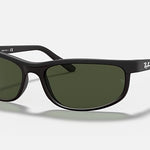 The Ray-Ban 2027 Predator 2 sunglasses feature a matte black finish, green-tinted lenses, signature logos on the right lens and temples, and sporty Predator temple tips, shown against a plain light background.