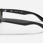 The Ray-Ban 2132 New Wayfarer polarized sunglasses are shown from the side, featuring the Ray-Ban logo on the temple and inner arm, set against a plain light background.