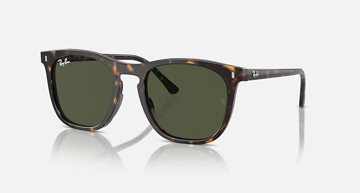 Ray-Ban 2210 sunglasses with a tortoiseshell frame and green lenses, styled in a classic Wayfarer look, are displayed against a plain white background.