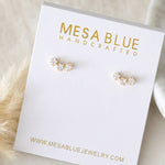 A pair of small Cz Star Climber Stud Earrings by Mesa Blue, featuring 18K gold plating and crystals, displayed on a white Mesa Blue Handcrafted jewelry card.