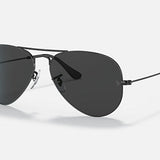 Ray-Ban 3025 Aviator sunglasses feature dark lenses and slim metal frames in a classic pilot style, shown on a light background.
