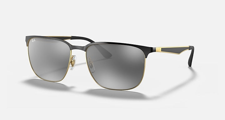 Ray-Ban 3569 sunglasses by Ray-Ban feature a rectangular black and gold square metal frame, double bridge, dark tinted lenses, and adjustable nose pads, shown on a plain light background.