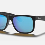 Ray-Ban 4165 Justin sunglasses with black frames and blue mirrored lenses shown on a plain light background.