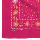 Bring a touch of encouragement to your day with the Jenni Earle Heritage Cotton Bandana – ‘for Goodness Sake’. Crafted from red cotton and adorned with a cheerful yellow and white floral pattern in classic western style, this neckerchief features “for goodness sake” scripted in cursive in the bottom left corner, making it both a charming accessory and a thoughtful gift.