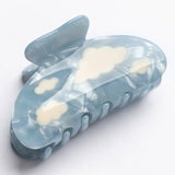 Lucy Hair Claw by Winona Irene in light blue cellulose acetate featuring a white cloud pattern.