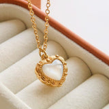 Josie Vintage Heart Pendant Necklace by Flanerie by MAIQ, a gold stainless steel chain with a vintage heart pendant featuring an iridescent white center in an ornate frame.