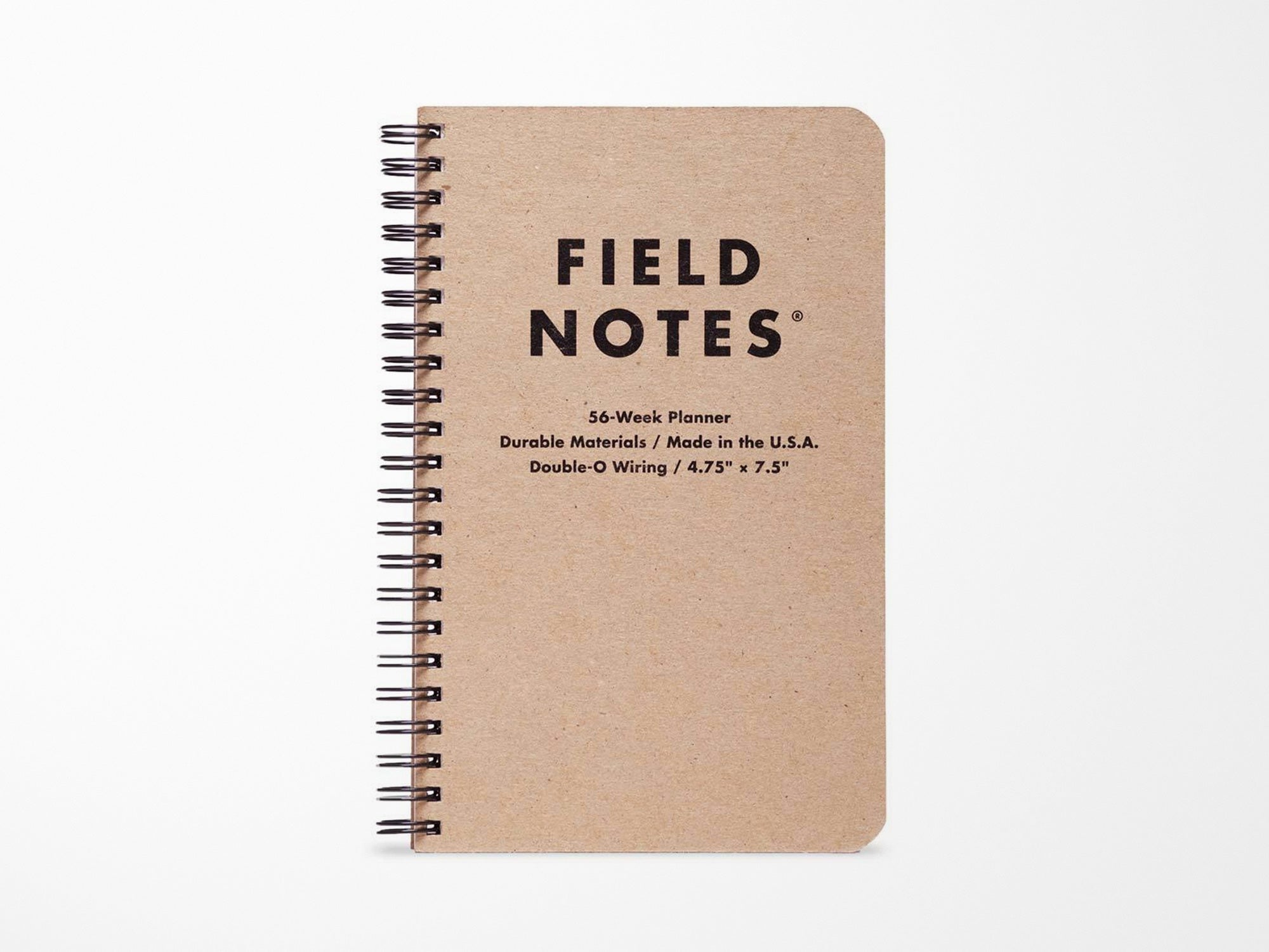 The Field Notes 56-Week Planner is a spiral-bound kraft paper planner with a durable chipboard cover, labeled "56-Week Planner | Field Notes," and includes details about its materials and size on the front.
