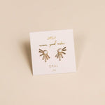 Sun Ray - White Opal - Gold Earrings by JaxKelly feature a sunburst design with lab-grown white opal stones, displayed on a branded card.