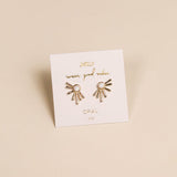 Sun Ray - White Opal - Gold Earrings by JaxKelly feature a sunburst design with lab-grown white opal stones, displayed on a branded card.