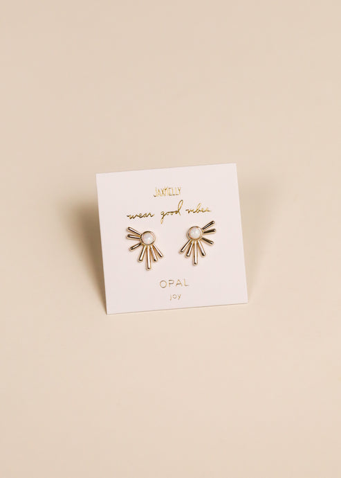 Sun Ray - White Opal - Gold Earrings by JaxKelly feature a sunburst design with lab-grown white opal stones, displayed on a branded card.