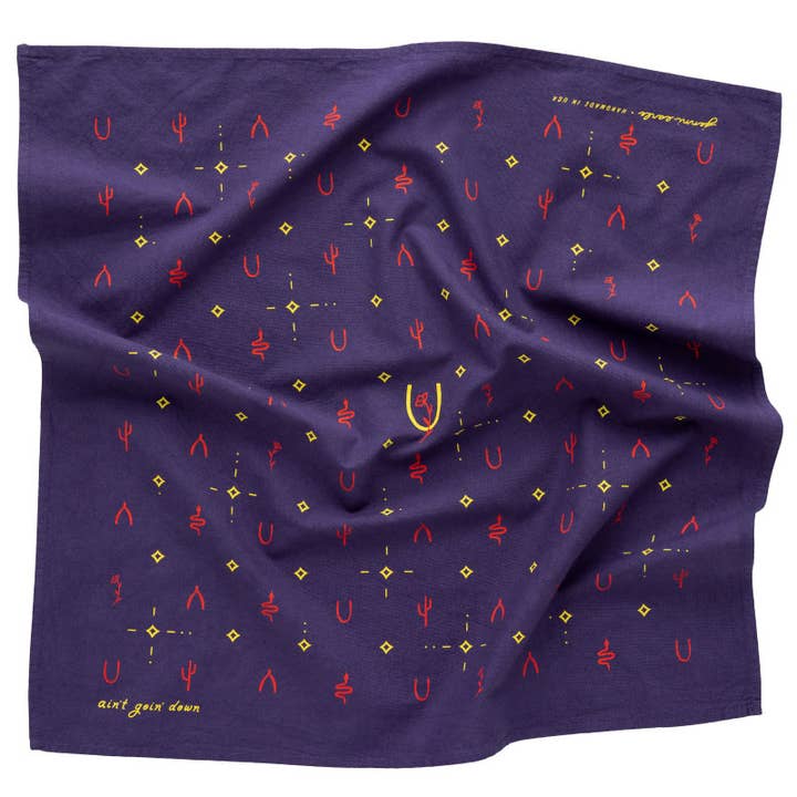 Introducing the Heritage Cotton Bandana - “Ain’T Goin’ Down” by Jenni Earle: a purple cotton bandana featuring red and yellow geometric and abstract symbols, such as repeating shapes and small diamonds, arranged in a grid pattern—ideal as an encouragement gift or to add a touch of western bandana style.
