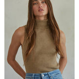 A person wearing a tan Knit Turtleneck Sleeveless Pullover Top in a sleeveless, ribbed turtleneck style.