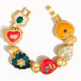 Elysian Baroque Heart Color Bracelet by Flanerie by MAIQ featuring matte 18K gold-plated heart charms with colorful enamel, embedded crystals, and small floral accents.