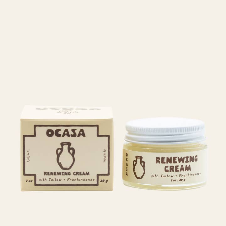 A jar of Renewing Frankincense-Infused Tallow Cream by OCASA next to its matching cardboard box, designed as a deeply nourishing moisturizer for mature skin.