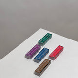 Five colorful rectangular boxes from the Espiritus del Ande Collection by Incausa are arranged on a white surface, each featuring unique designs inspired by natural incense and Palo Santo blends handcrafted in Peru.